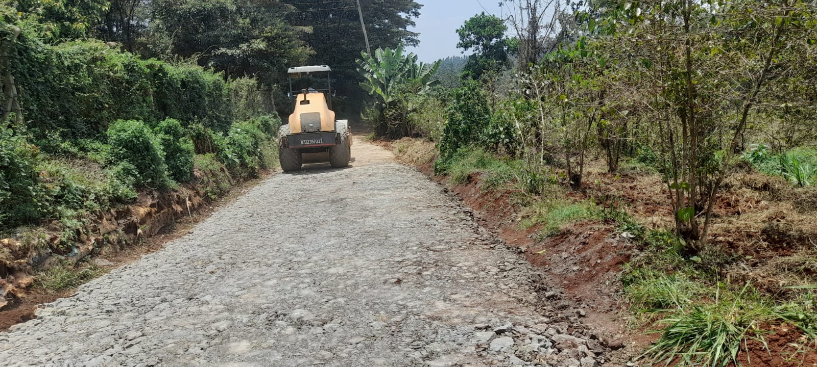Roller compacting the newly graveled Gathigi Road