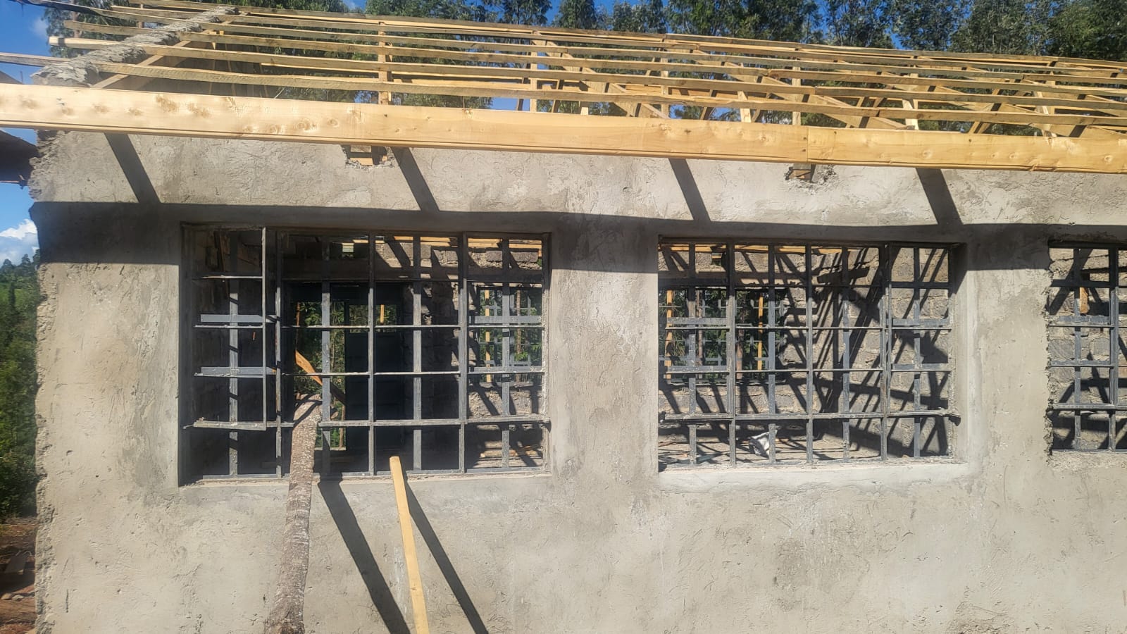 Plastered classroom walls and window frames during construction