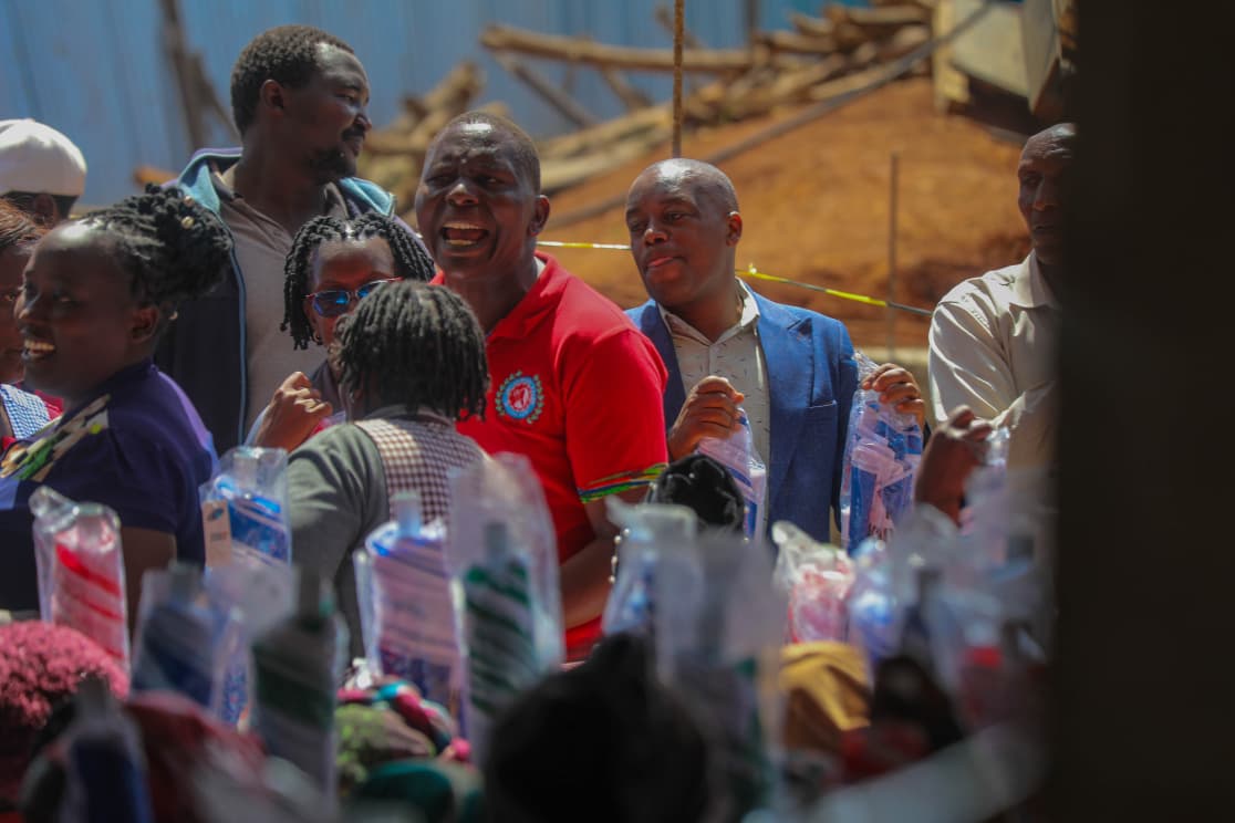 Traders receiving umbrellas and equipment at Githunguri Market